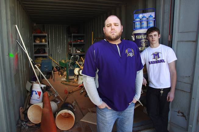 Baseball coach Nick Grove and player Bryce Durham stand next to the baseball storage shed at Sunrise Mountain High School on Wednesday, Jan. 8, 2014. At some point during the previous summer, the shed was broken into and almost everything was stolen.