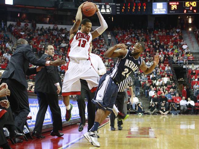 UNLV guard Bryce Dejean Jones bounces the ball off UNR guard Deonte Burton to send it out of bounds during their Mountain West Conference game Wednesday, Jan. 8, 2014 at the Thomas & Mack Center. UNR won 74-71, handing the Rebels their second straight home loss.