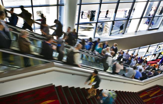 Attendees to CES make their way to various exhibit halls at the Las Vegas Convention Center on Wednesday, Jan. 8, 2014.