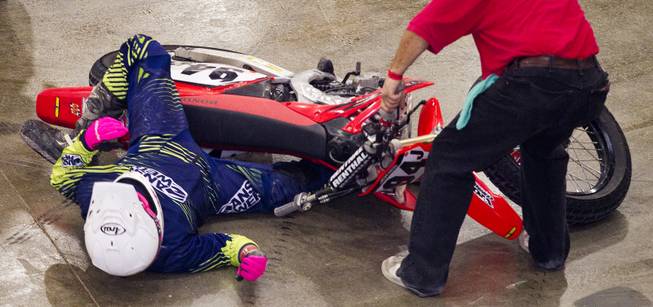 Rider Kyle Jones (94J) has his leg trapped after a fall during a heat race in the West Coast Flat Track Series Races at South Point on Friday, Jan. 10, 2014.