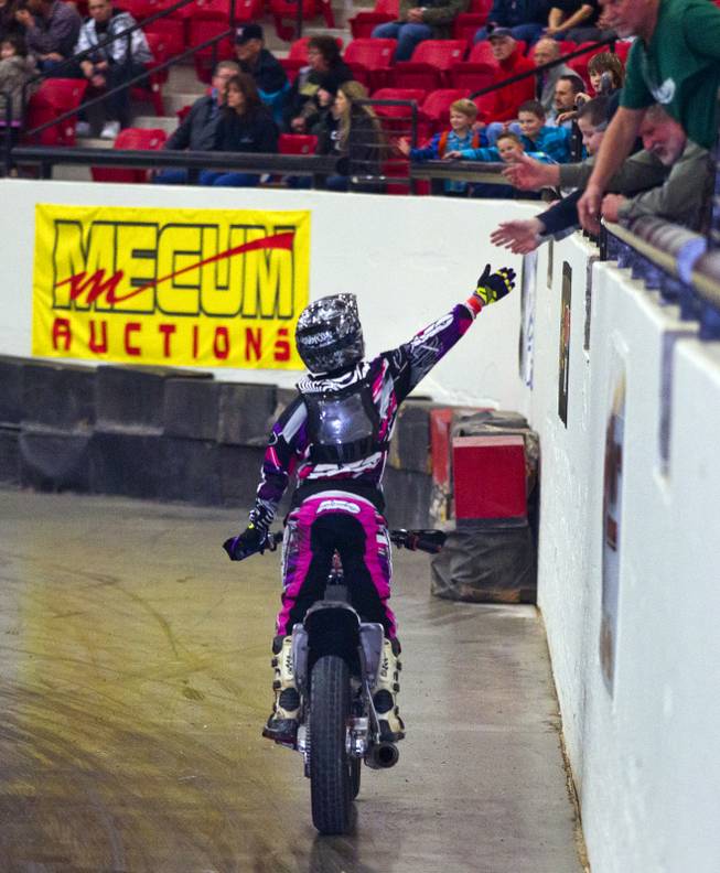 Rider Vaughn McCafferty (11F) celebrates his victory with fans in the Top Gun 450 Class during the West Coast Flat Track Series Races at South Point on Friday, Jan. 10, 2014.