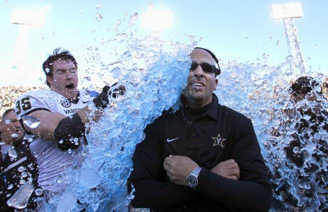 Vanderbilt coach James Franklin is doused by linebacker Chase Garnham after the Commodores defeated Houston 41-24 in the BBVA Compass Bowl NCAA college football game on Saturday, Jan. 4, 2014, in Birmingham, Ala.