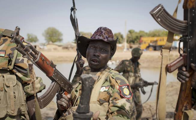 A South Sudanese government soldier chants in celebration after government forces on Friday retook from rebel forces the provincial capital of Bentiu, in Unity State, South Sudan, Sunday, Jan 12, 2014.