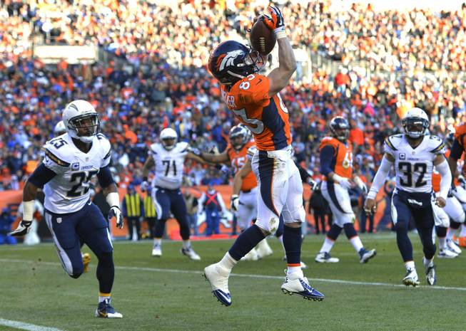 Denver Broncos wide receiver Wes Welker catches a pass for a touchdown against the San Diego Chargers in the second quarter of an NFL playoff game Sunday, Jan. 12, 2014, in Denver.