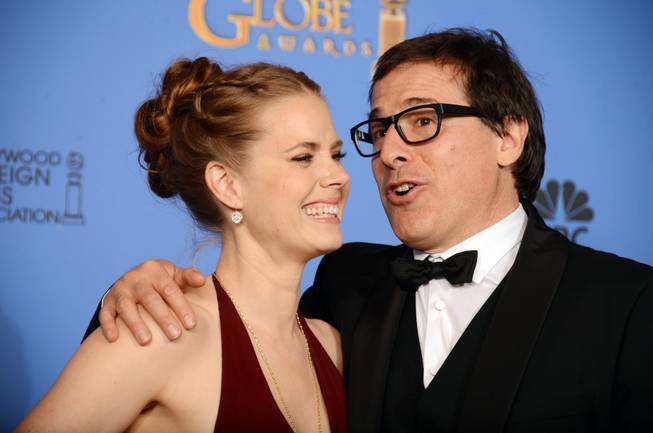 Amy Adams and David O. Russell, winners of Best Motion Picture, Comedy or Musical, for "American Hustle," celebrate in the press room at the 71st annual Golden Globe Awards at the Beverly Hilton Hotel on Sunday, Jan. 12, 2014, in Beverly Hills, Calif.