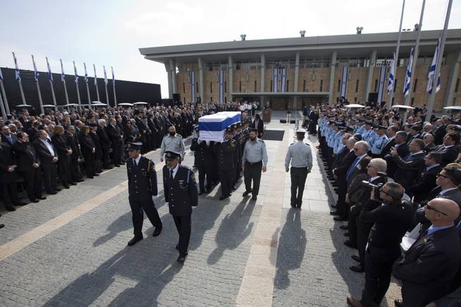 The coffin of late Israeli Prime Minister Ariel Sharon is carried after a memorial ceremony outside the Knesset, in Jerusalem, Monday, Jan. 13, 2014. 