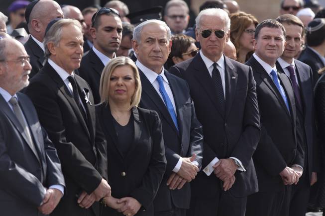 U.S. Vice President Joe Biden, wearing sunglasses, stands with Israeli Prime Minister Benjamin Netanyahu, his wife Sarah, and Former British Prime Minister and Mideast Envoy Tony Blair. during a ceremony for late Israeli Prime Minister Ariel Sharon at the Knesset plaza, Israel's Parliament, in Jerusalem, Monday, Jan. 13, 2014.