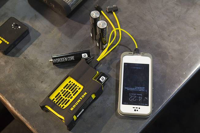 A Brunton Reactor charges a smartphone during the 2014 SHOT Show (Shooting, Hunting, Outdoor Trade) at the Sands Expo & Convention Center Tuesday, Jan. 14, 2014.  The device ($149.00 with two cores) uses hydrogen to generate electricity for recharging USB mobile devices.