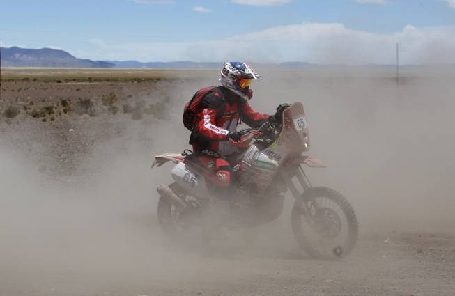 Honda rider Eduardo Heinrich of Peru races during the eighth stage of the Dakar Rally between the cities Uyuni, Bolivia and Calama, Chile in Kui, Bolivia, Monday, Jan. 13, 2014. 