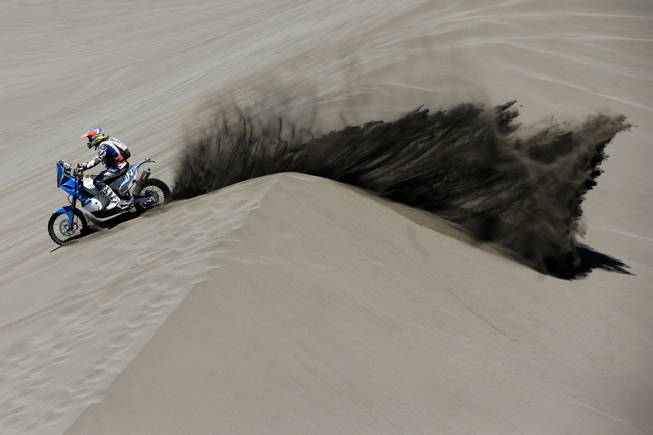 KTM rider Mark Davidson of Australia races through the dunes during the second stage of the Dakar Rally between the cities of San Luis and San Rafael in San Rafael, Argentina,  Monday, Jan. 6, 2014. The second stage is regarded as one of the fastest in the two-week rally, which ends Jan. 18 in Valparaiso, Chile. 