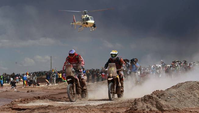 Speedbrain rider Jeremias Isarael Esquerre of Chile, left center,  and KTM rider Jordi Viladoms of Spain race during the seventh stage of the Dakar Rally between the cities of Salta, Argentina and Uyuni Bolivia, Sunday, Jan. 12, 2014. 