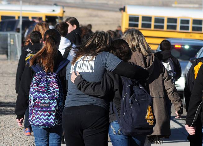 Students are escorted from Berrendo Middle School after a shooting incident, Tuesday, Jan. 14, 2014, in Roswell, N.M. Roswell police said the suspected shooter was arrested the school, but authorities have not said if there were any injuries. The school has been placed on lockdown. No other details are yet available.
