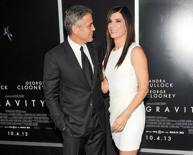 George Clooney and Sandra Bullock attend the premiere of "Gravity" at the AMC Lincoln Square Theaters on Tuesday, Oct. 1, 2013, in New York. 