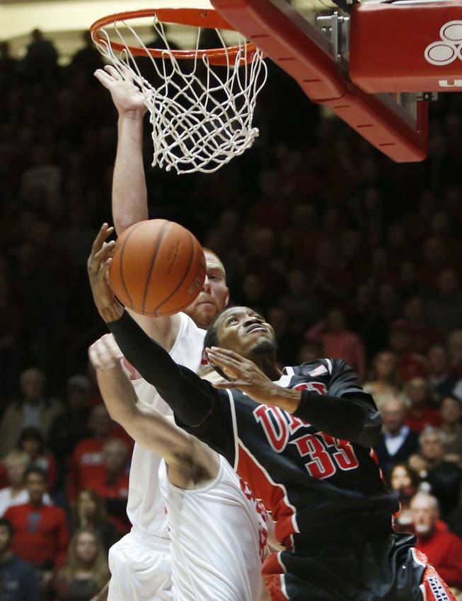 UNLV's Deville Smith (33) tries to score in front of New Mexico's Alex Kirk in the first half of an NCAA college basketball game on Wednesday, Jan. 15, 2014, in Albuquerque. 