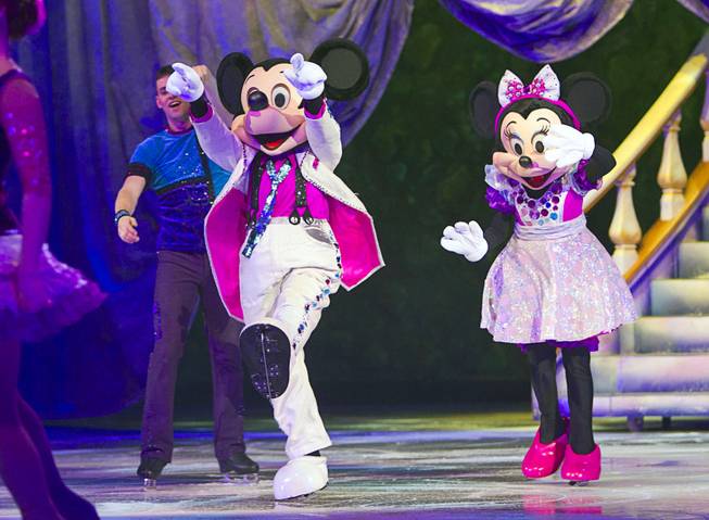 Mickie Mouse and Minnie Mouse arrive for an opening number during "Disney On Ice: Rockin' Ever After" at the Thomas & Mack Center Thursday, Jan. 16, 2014. The show plays at the center through Sunday.