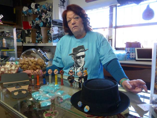Debbie Ball, known locally as "The Candy Lady," poses with "Breaking Bad" kitsch she sells in her store, including candy made to look like blue meth crystals, Jan. 16, 2014, in Albuquerque.