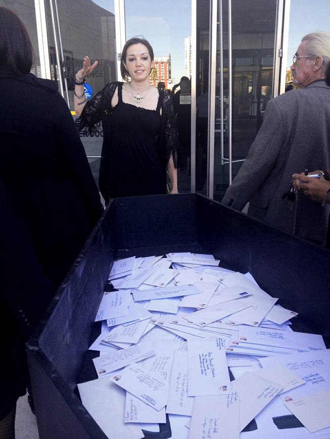 GMO-Free Las Vegas leader Angie Morelli deliveres 109 stamped envelopes with letters to Nevada's congressional delegation encouraging them not to support the controversial Trans-Pacific Partnership, a 12-nation trade agreement. The letters, placed in a coffin, arrived at the Lloyd D. George Federal Courthouse via a hearse on Thursday, Jan. 16, 2014.