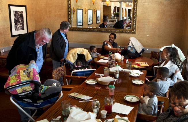 The Derrico family are greeted by another couple dining at the Olive Garden after a doctor visit Friday, Dec. 17, 2013.
