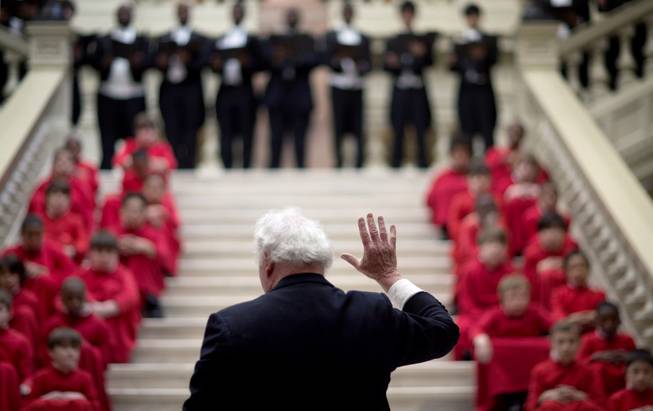 Conductor Fletcher Wolfe directs the Atlanta Boy Choir and Alumni Men's Choir at a ceremony paying tribute to Rev. Martin Luther King, Jr., at the Statehouse, Friday, Jan. 17, 2014, in Atlanta. 