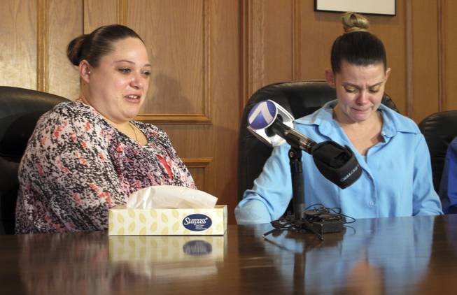Amber McGuire, left, recounts the execution of her father, Dennis McGuire, as her sister-in-law Missie McGuire cries at a news conference Friday, Jan. 17, 2014, in Dayton, Ohio, where they announced a planned lawsuit against the state over the unusually slow execution.
