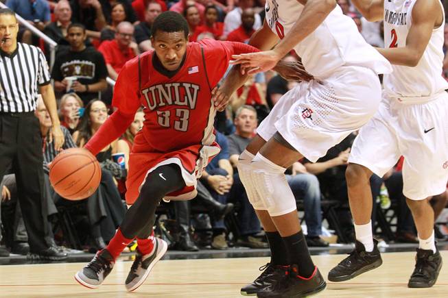 UNLV guard Deville Smith drives to the lane against San Diego State during their game Saturday, Jan. 18, 2014 at Viejas Arena in San Diego. The 10th ranked SDSU won the game 63-52.