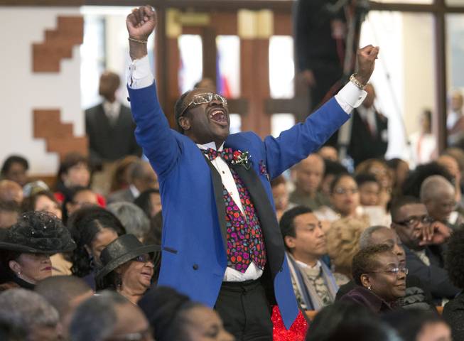 Elder Cal Murrell reacts to a speaker during the Rev. Martin Luther King Jr. holiday commemorative service at Ebenezer Baptist Church Monday, Jan. 20, 2014, in Atlanta. The service at the church where King preached featured prayers, songs, music and speakers. 