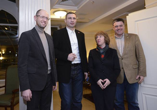 EU foreign policy chief Catherine Ashton, second right, prior her meeting with  Ukrainian opposition leaders, Oleh Tyahnybok, right, Arseniy Yatsenyuk, left, and Vitali Klitschko, second left,  in Kiev, Ukraine, Tuesday, Dec. 10, 2013. Top Western diplomats headed to Kiev Tuesday to try to defuse a stand-off between President Viktor Yanukovych's government and thousands of demonstrators, following a night in which police in riot gear dismantled protesters' encampments outside government buildings. Demonstrators have occupied the Ukrainian capital for weeks opposing Yanukovych's decision to freeze ties with the European Union and tilt to Russia instead.