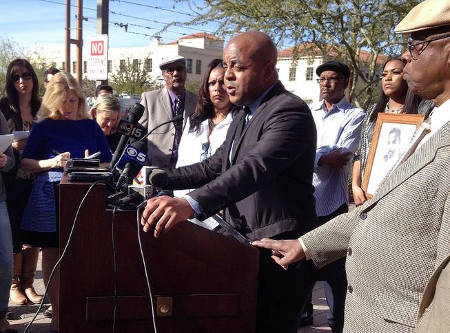 The Rev. Jarrett Maupin, center, an Arizona civil rights activist, speaks during a news conference in Phoenix, Tuesday, Jan. 21, 2014, after an Arizona State University fraternity hosted a distasteful party in commemoration of Martin Luther King Jr. Day, replete with racist stereotypes and offensive costumes. 