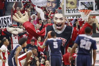 The UNLV student section unveils the giant Khem Kong prop as Utah State center Jarred Shaw shoots a free throw during their game Wednesday, Jan. 22, 2014, at the Thomas & Mack Center.