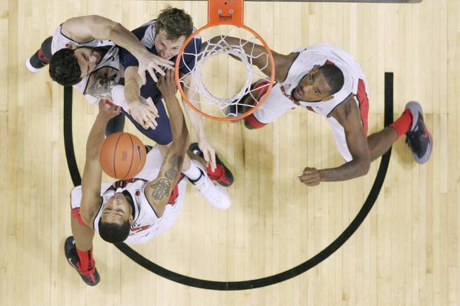 UNLV's Carlos Lopez Sosa, Jelan Kendrick and Roscoe Smith fight Utah State forward Ben Clifford for a rebound during their game Wednesday, Jan. 22, 2014 at the Thomas & Mack Center. UNLV won 62-42.