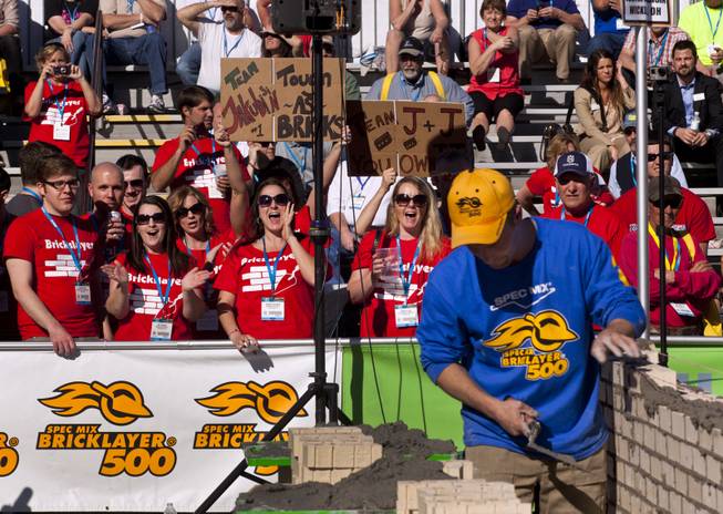 Fans cheer on Team Jakubin as time winds down during the Spec Mix "Bricklayer 500"   competition at the 40th anniversary of the World Of Concrete event outside the Las Vegas Convention Center on Wednesday, Jan. 22, 2014.