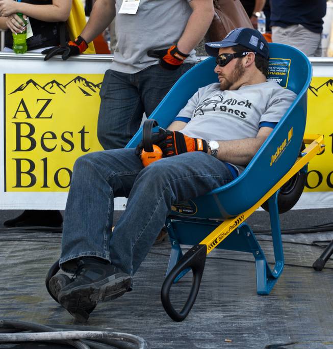 Morgan Agazzi of Livonia, Mich., catches a quick break in a wheelbarrow nearing the finish of the Spec Mix "Bricklayer 500" competition during the 40th anniversary of the World Of Concrete event outside the Las Vegas Convention Center on Wednesday, Jan. 22, 2014.