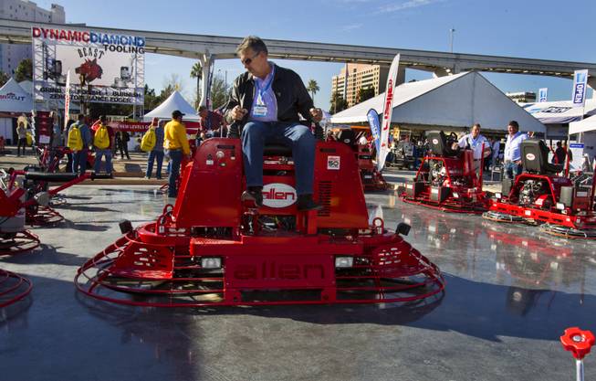 An Allen Engineering concrete paver is operated while sitting atop twin blades during 40th anniversary of the World Of Concrete at the Las Vegas Convention Center on Wednesday, Jan. 22, 2014.