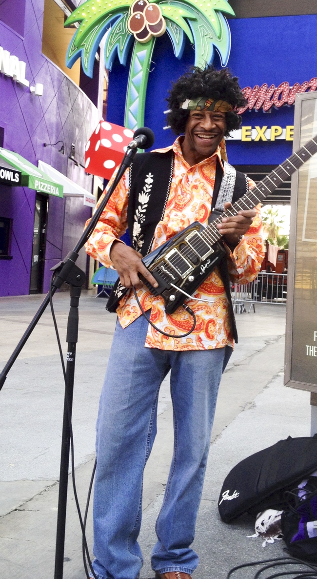 Lenny Payne plays Jimi Hendrix in front of Slotzilla in Fremont street experience Wednesday, Jan. 22. 2014. 
