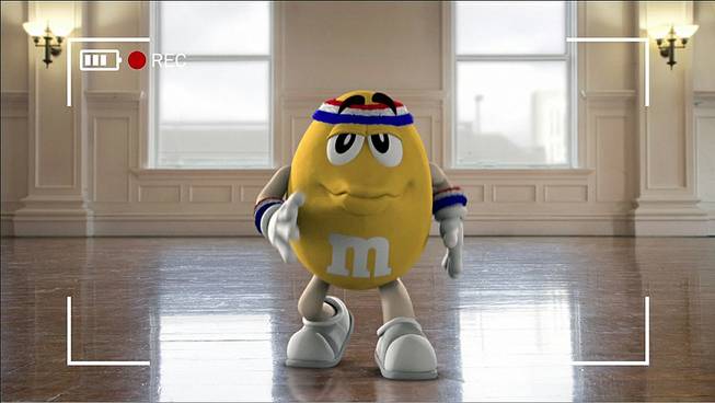 This image provided by Mars Inc. shows an online teaser ad for M&M's Super Bowl ad featuring its yellow peanut M&M “spokescandy.”