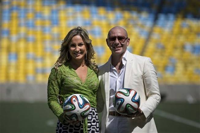 Brazilian singer Claudia Leitte and rapper Pitbull pose for the media during a news conference at the Maracana stadium in Rio de Janeiro, Brazil, Thursday, Jan. 23, 2014. Leitte, along with Jennifer Lopez and Pitbull, will perform the official song for the 2014 World Cup. Football's governing body didn't elaborate when the song, written and co-produced by Pitbull will be released.