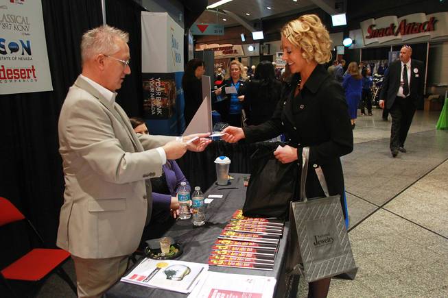 Markus Van't Hul from KNPR and KCNV trades business cards with Jennifer Mahar during the Las Vegas Metro Chamber of Commerce "Preview Las Vegas" event Friday, Jan. 24, 2014.