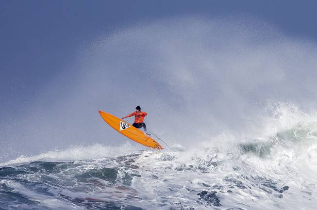 Tyler Fox flies out of a wave during the second heat of the first round of the Mavericks Invitational big wave surf contest Friday, Jan. 24, 2014, in Half Moon Bay, Calif.