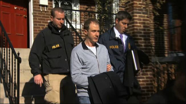 This Dec. 11, 2013, image from video provided by WJLA-TV, shows Ryan Loskarn, former chief of staff to Sen. Lamar Alexander, R-Tenn., being escorted from his Washington home by U.S. Postal Inspector police. Loskarn has been found dead in Maryland, just weeks after the former staffer's arrest on child pornography charges.