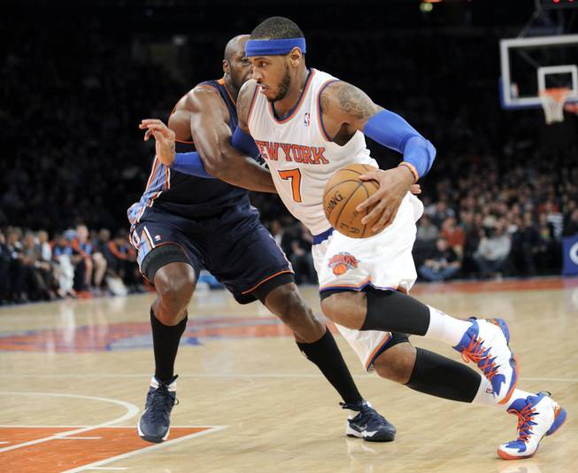 New York Knicks' Carmelo Anthony, right, drives by Charlotte Bobcats' Anthony Tolliver during the second quarter of an NBA basketball game, Friday, Jan. 24, 2014, at Madison Square Garden in New York. 