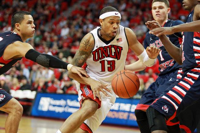 UNLV guard Bryce Dejean Jones is fouled by Fresno St. guard Cezar Guerrero during their game Saturday, Jan. 25, 2014 at the Thomas & Mack Center. UNLV won 75-73 in overtime.