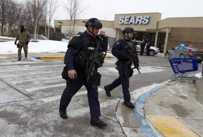 Police move in from a parking lot to the Mall in Columbia after reports of a multiple shooting, Saturday Jan. 25, 2014 Howard County, Md.