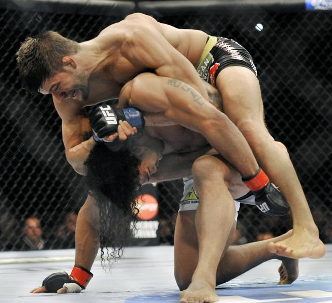 Josh Thomson, top, wrestles Benson Henderson during the main event of the UFC mixed martial arts event in Chicago, Saturday, Jan., 25, 2014. 