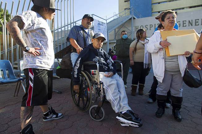 Francisco Diaz of Las Vegas is met by family members outside the general hospital after a doctor's appointment in Mexicali, Mexico Sunday, Jan. 26, 2014. Diaz was born in Mexico but grew up in Las Vegas with a green card. Diaz was beaten and robbed after he was deported to Mexicali.
