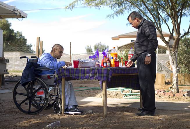Francisco Diaz eats with Dr. Francisco Lopez at the elderly care home where he is recovering from injuries in Mexicali, Mexico Sunday, Jan. 26, 2014. Diaz was beaten and robbed after he was deported to Mexicali.