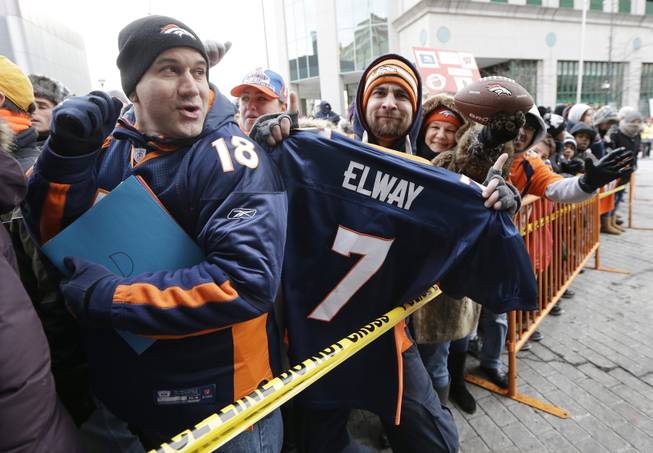 Denver Broncos fans wait for players to arrive at the team hotel Sunday, Jan. 26, 2014, in Jersey City, N.J. The Broncos are scheduled to play the Seattle Seahawks in the NFL Super Bowl XLVIII football game Sunday, Feb. 2, in East Rutherford, N.J. 