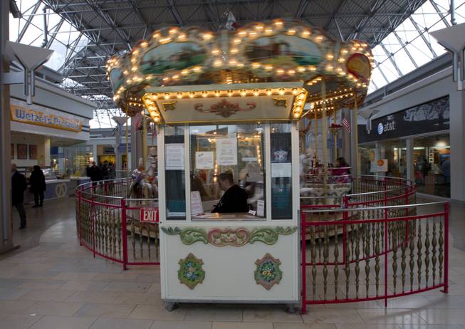 Carousel manager Down Foster waits for customers at The Mall in Columbia after the mall re-opened to the public on Monday Jan. 27, 2014.