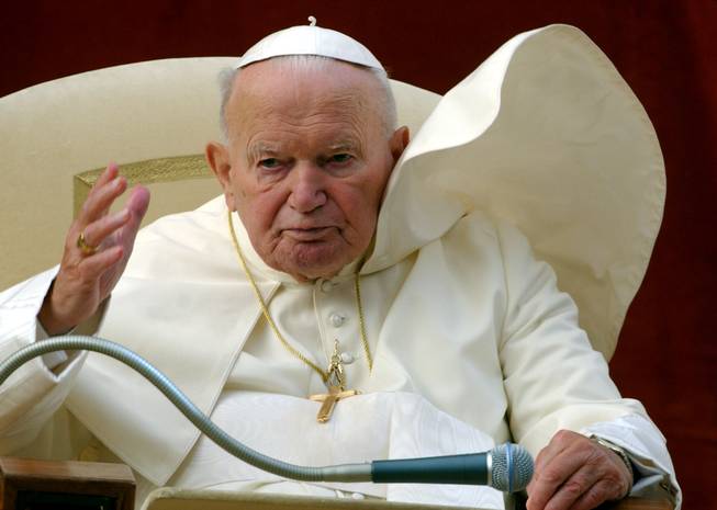 In this Wednesday, Aug. 18, 2004, file photo, Pope John Paul II blesses the faithful during the weekly general audience in the courtyard of his summer residence of Castelgandolfo, in the outskirts of Rome. Police are searching an Italian mountain area beloved by Pope John Paul II for a stolen relic bearing his blood.