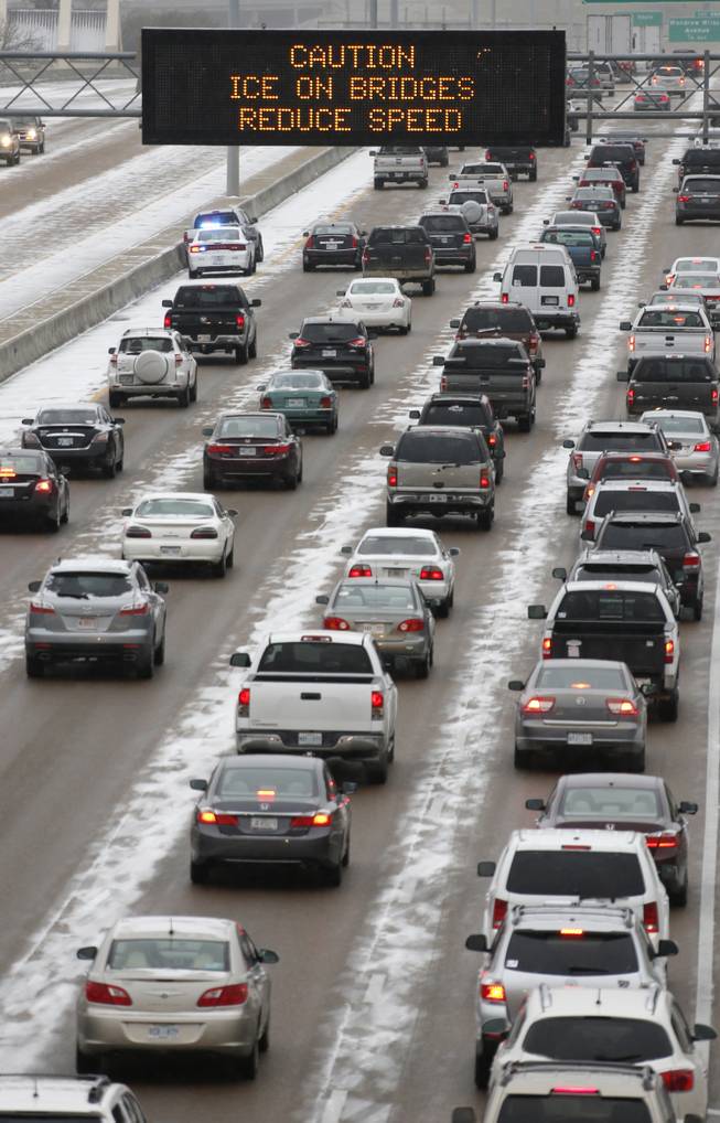 Traffic creeps along Interstate 55 in north Jackson, Miss., Tuesday, Jan. 28, 2014, as ice and snow flurries cause difficult driving conditions. A severe winter storm is expected to hit the state bringing ice and snow to the Gulf Coast. 
