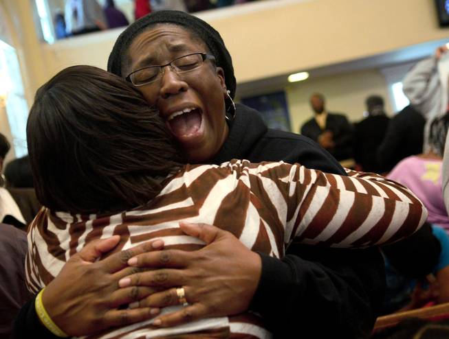 Charita Grant, left, holds Karey Pierre, right, while she cries out in prayer on Tuesday, Jan. 28, 2014, after the Concert of Prayer at Word Tabernacle Church in Rocky Mount, N.C. Pierre, a teacher at SouthWest Edgecombe High School, was at the church when four youths were shot Monday behind the building on the basketball court.